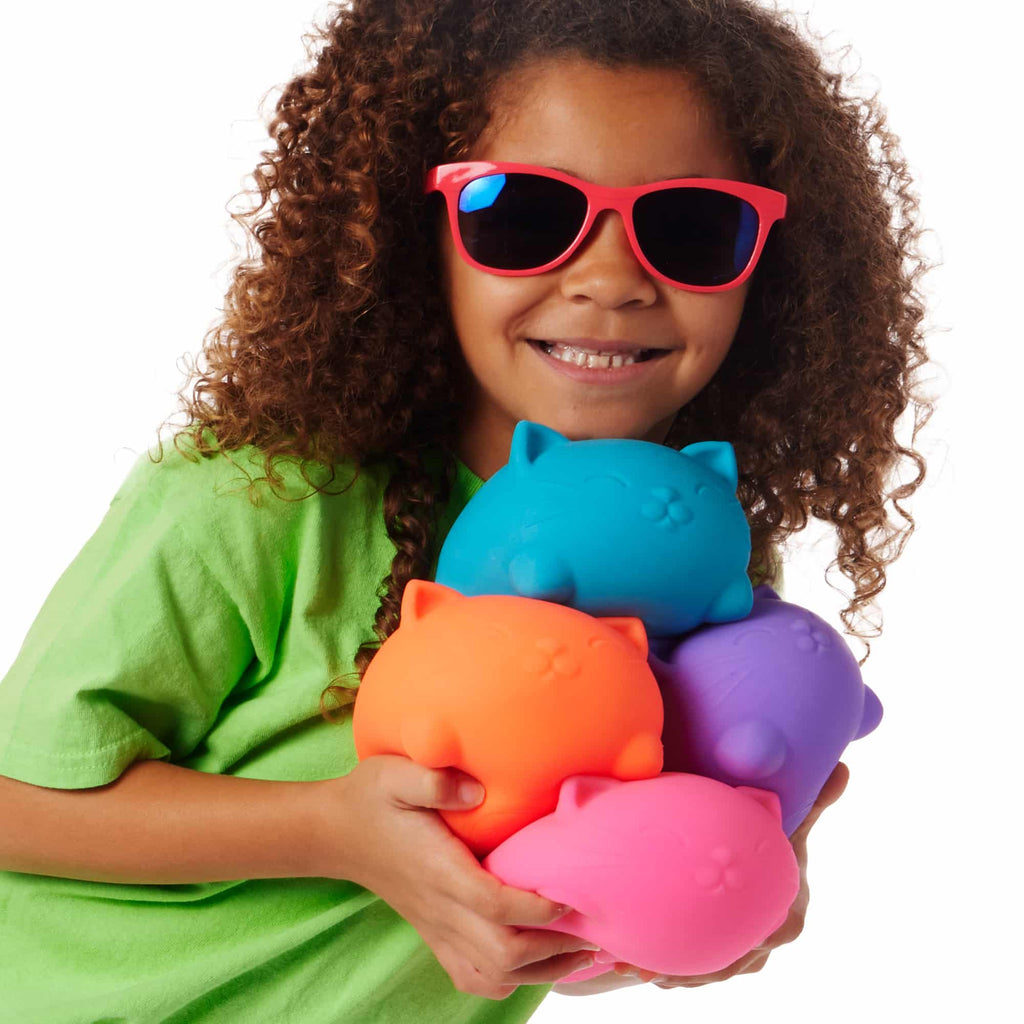 NeeDoh Super Cool Cats - Lifestyle with girl holding all four colors Super Cool Cats