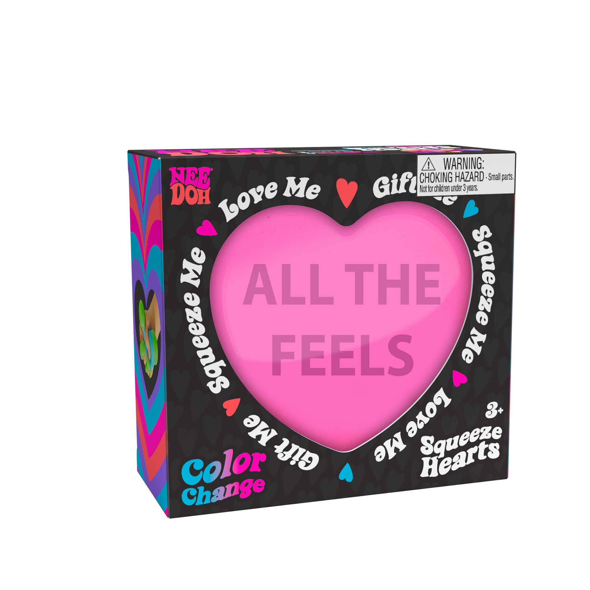 A boxed Nee Doh Color Change Squeeze Heart toy. The packaging is predominantly black with colorful accents, featuring phrases like "ALL THE FEELS," "Squeeze Me," "Love Me," and "Gift Me." The box also includes a choking hazard warning for small parts.