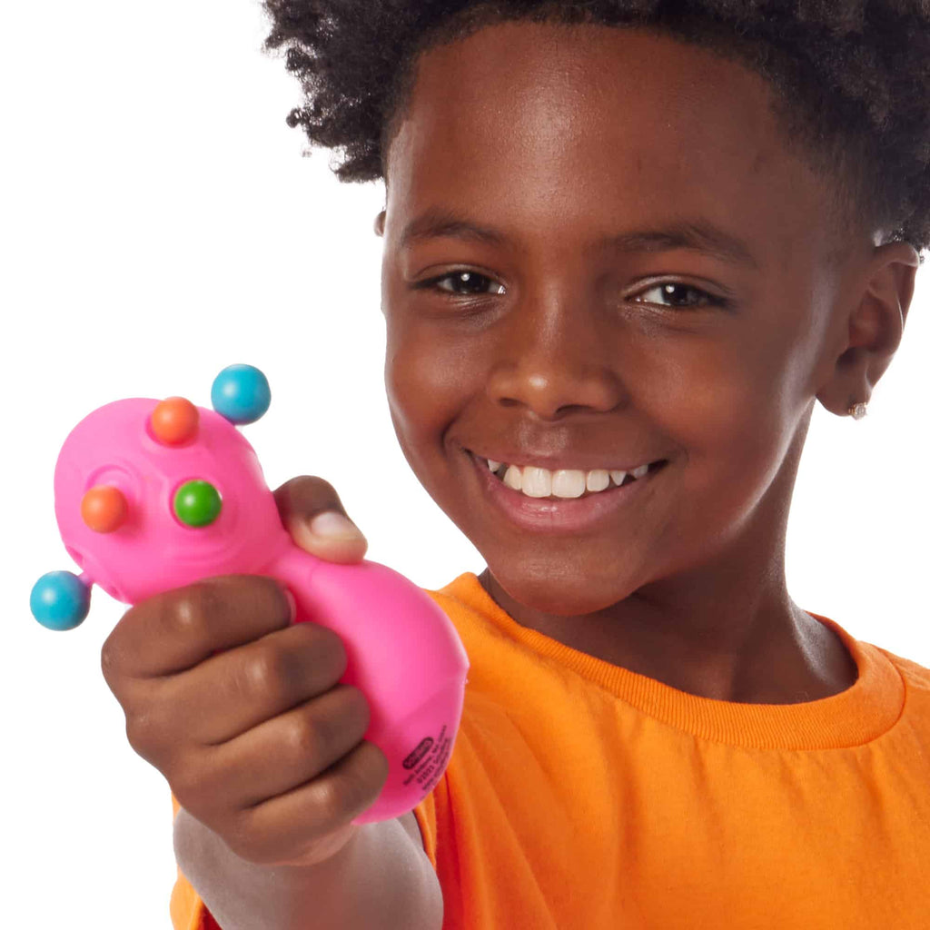 NeeDoh Panic Pete Lifestyle closeup of happy boy squeezing pink Panic Pete