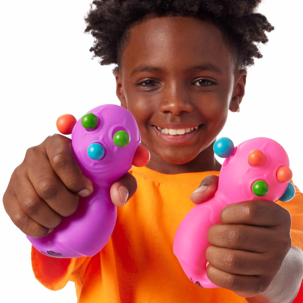 NeeDoh Panic Pete Lifestyle with boy squeezing purple and pink Panic Petes